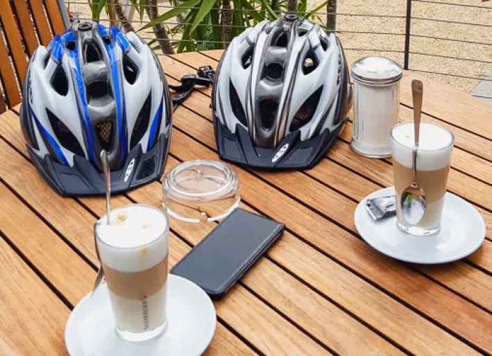 Latte macchiato and helmets on the table